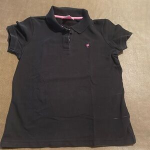 Black polo short sleeved shirt.